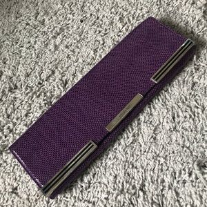 Purple snakeskin clutch with silver detail.